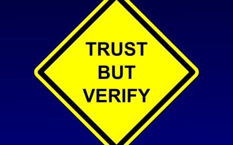 Street sign made to say Trust But Verify